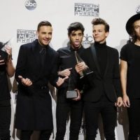 One Direction poses with their awards during the 42nd American Music Awards in Los Angeles